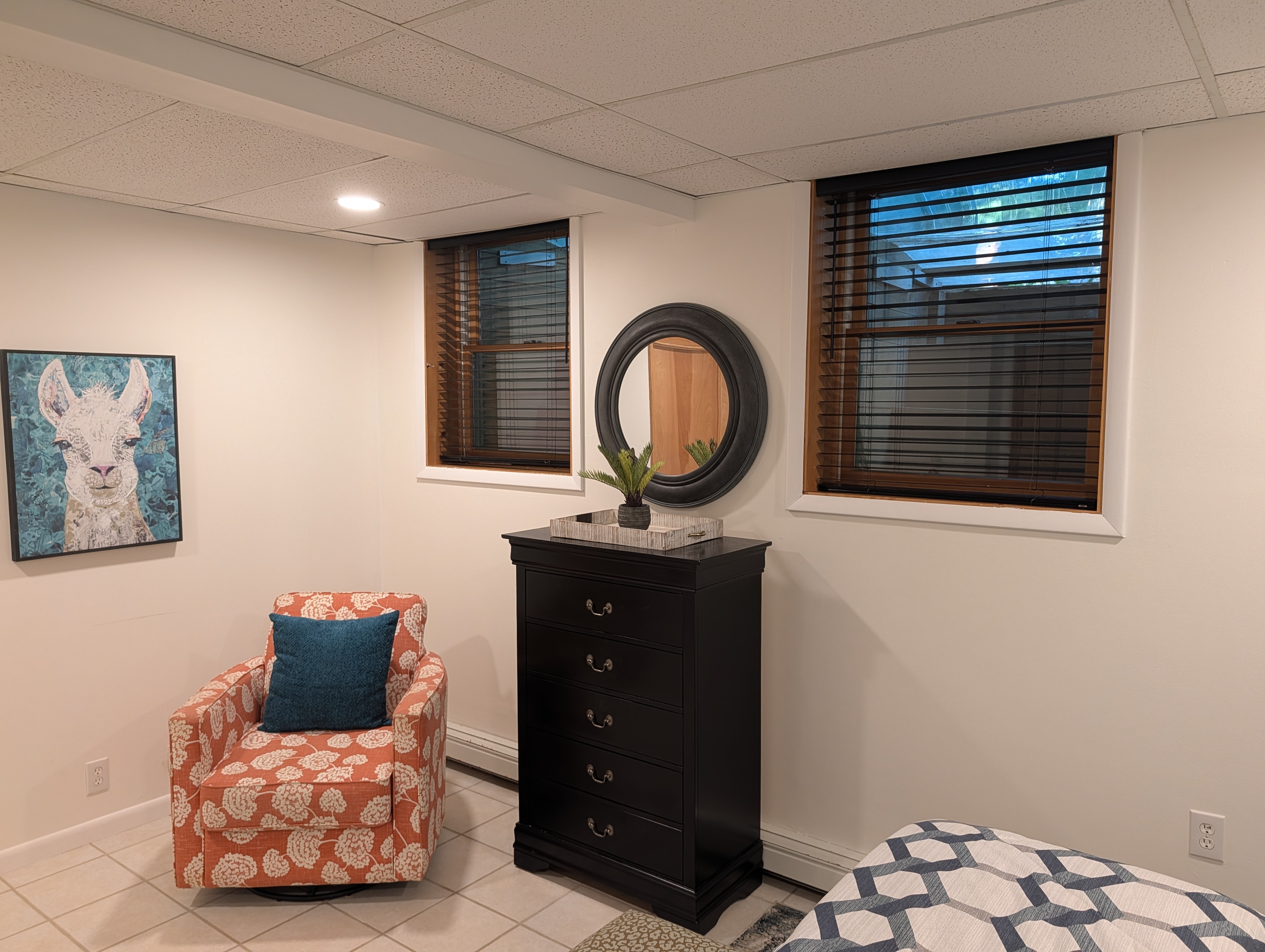 BEDROOM #1 (FIRST FLOOR):  Features a queen-size bed, nightstands, lamps, chair, dresser, and closet.