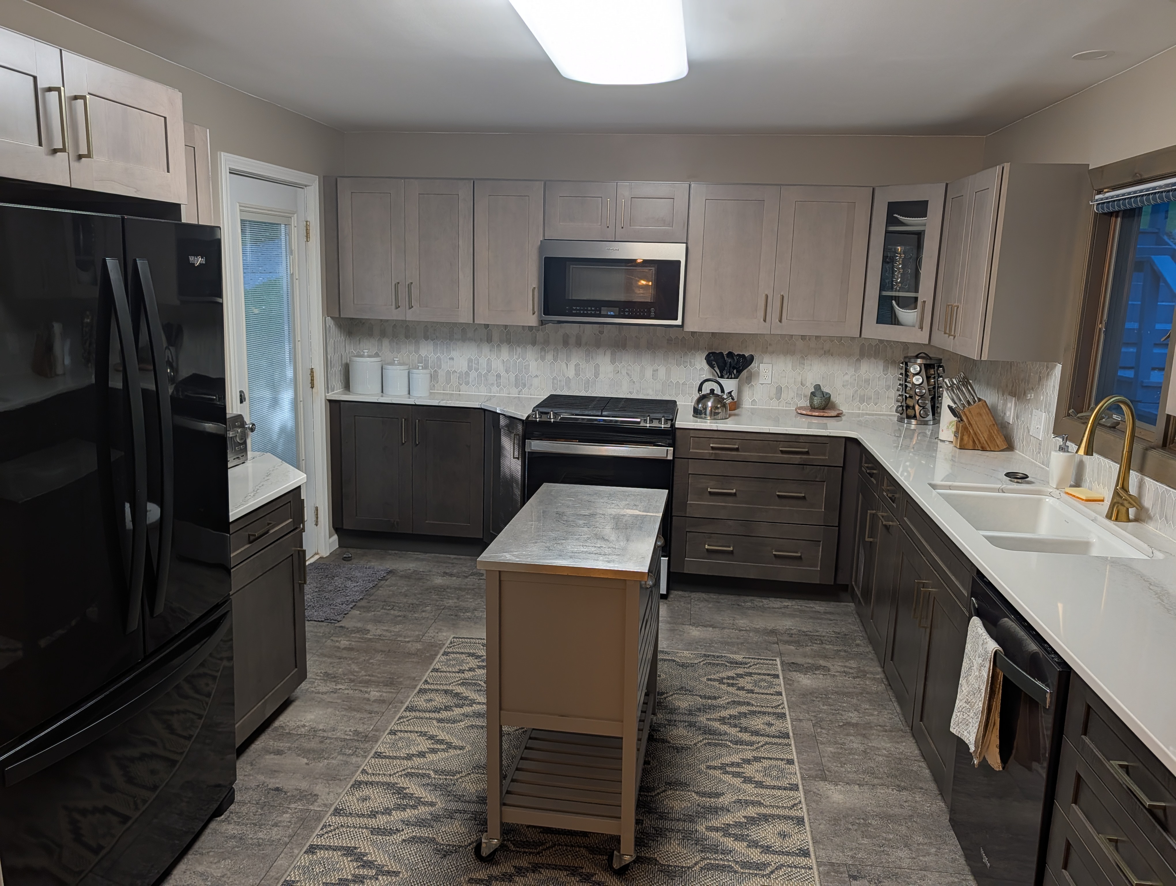 KITCHEN (SECOND FLOOR):  Large modern kitchen with a portal island and all appliances including a dishwasher and microwave.