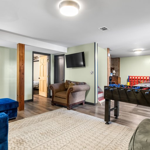 Lower-level lounge with a TV, foosball and giant Connect Four