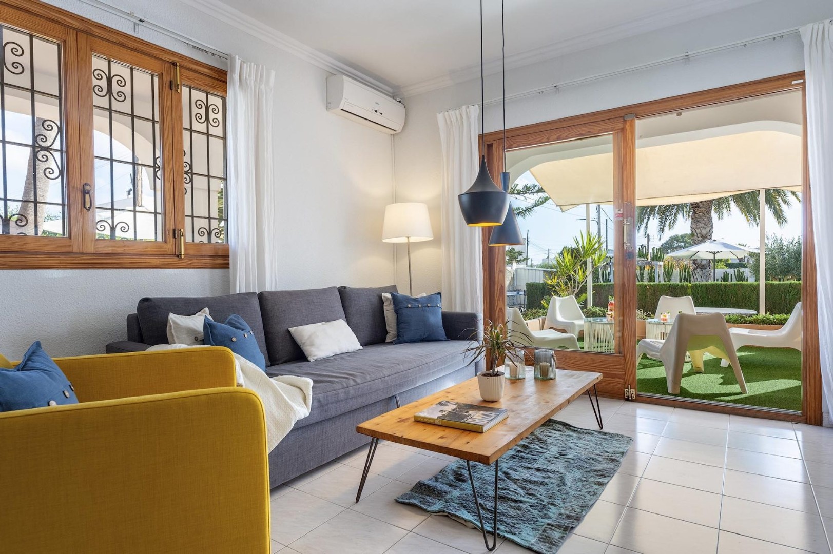 The fireplace and media corner, a cosy focal point for evenings in. Living room at Villa Kiku, Ibiza.